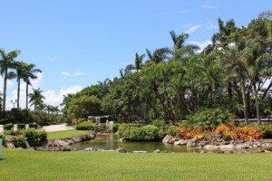 A park with trees and grass in the foreground.